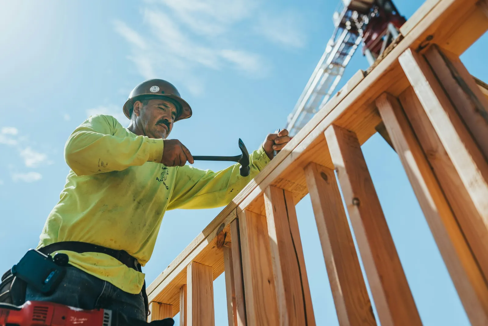 A builder framing the timber structure of a new house