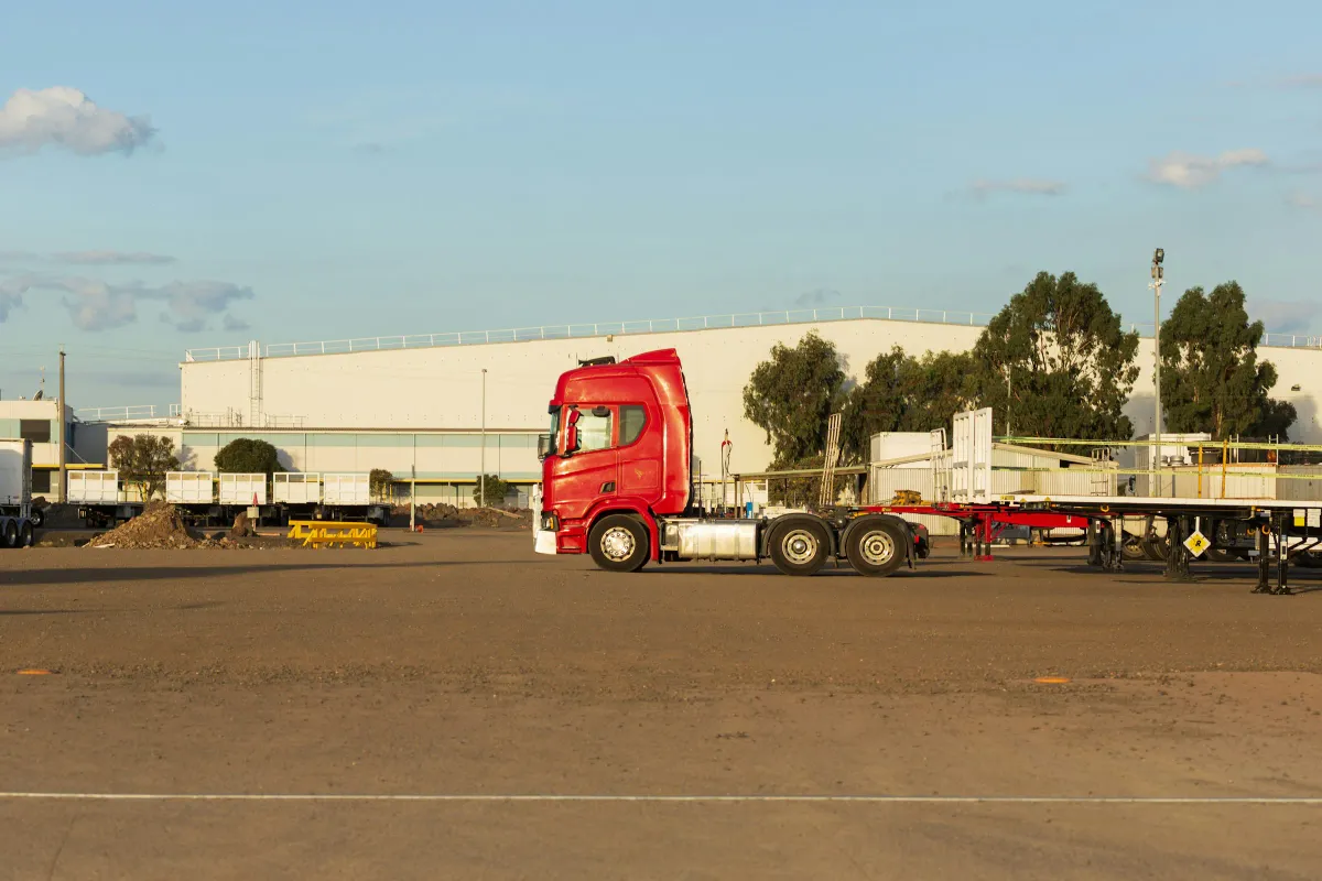 A red prime mover parked outside an industrial warehouse in Altona, Victoria