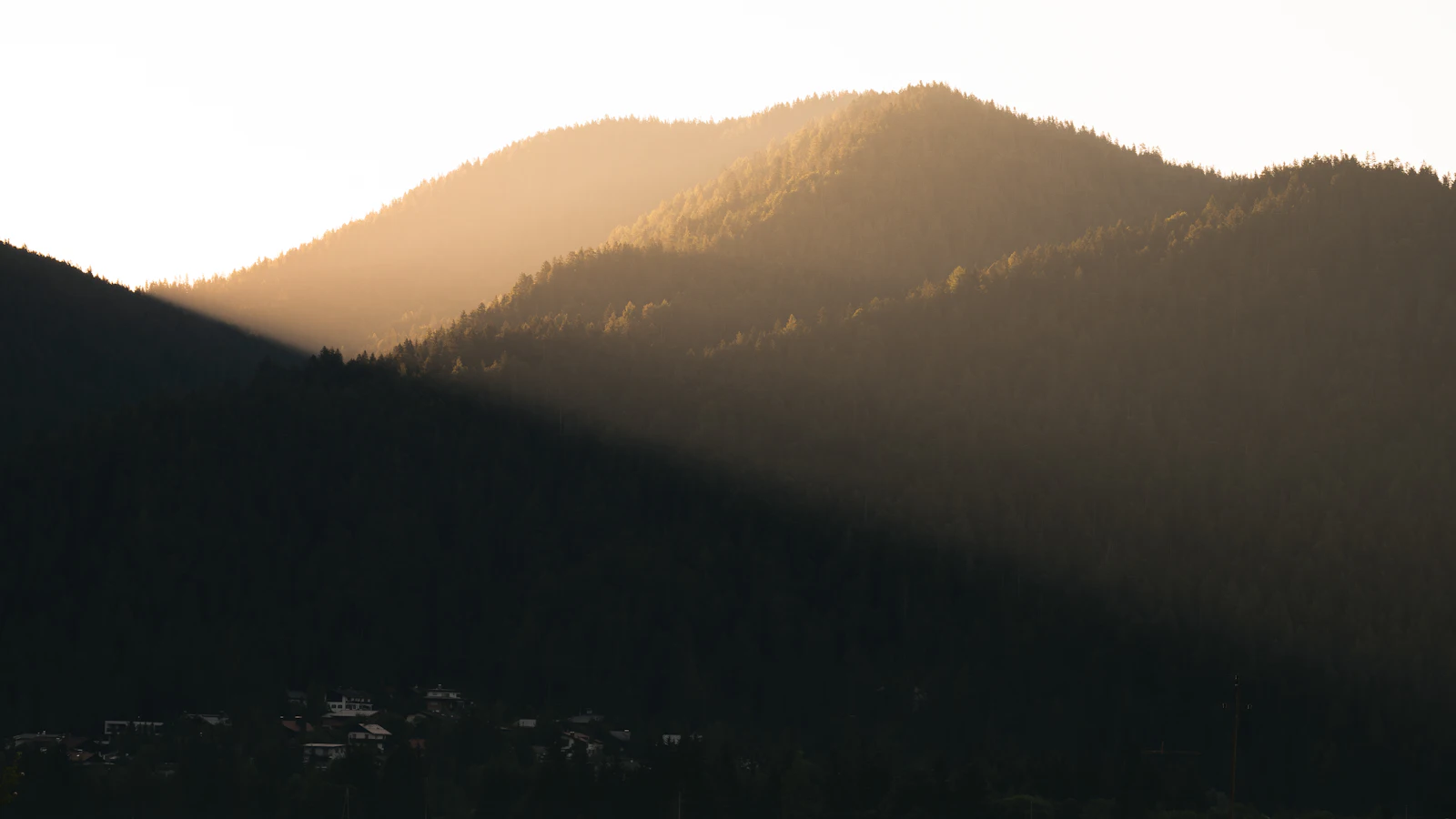 Morning light over a mountain ridge above a sea of fog